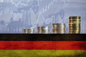 Coins on top of the flag of Germany on the background of oil rigs and charts. Concept - increase in the cost of gasoline, diesel, energy in Germany. Increase in the selling price of hydrocarbons.njemačka, inflacija, rast cijena, troškovi, porast troškova, industrija, proizvodnja