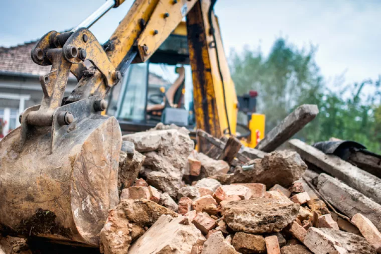 Hydraulic crusher excavator backoe machinery working on site demolition