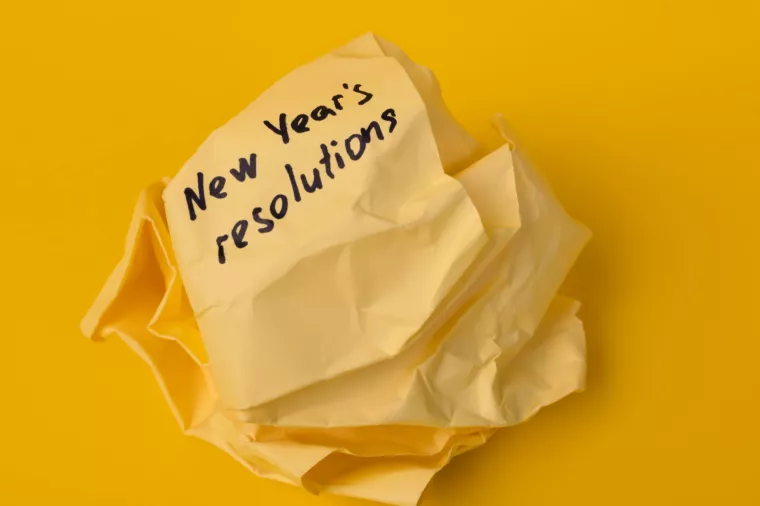 Crumpled paper with New Year's resolutions. The concept of failure at the beginning of a new life.