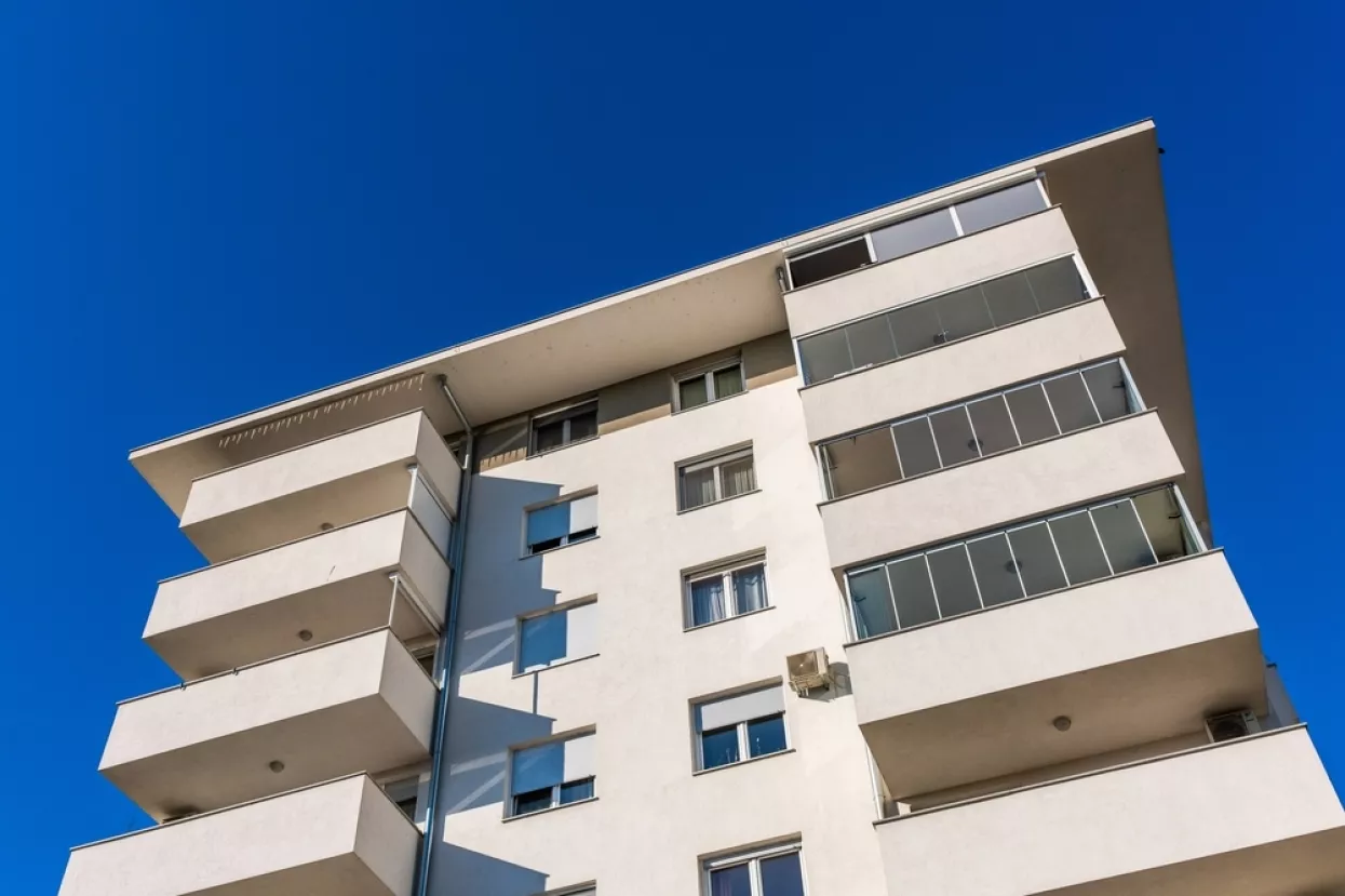 Zagreb, Croatia, October 20th, 2024A modern residential building featuring balconies with glass railings and a beige facade under a clear sky in Zagreb.Zagreb, stanovi. zgrada, zgrade, priu&scaron;tivo stanovanje