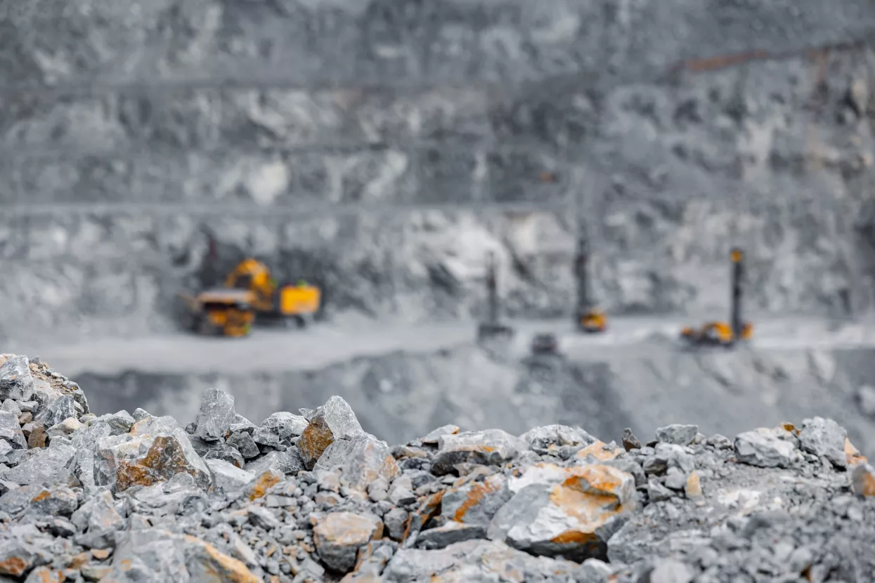 Industry open pit mine for extraction of gold, copper and iron using big yellow truck industrial machines.